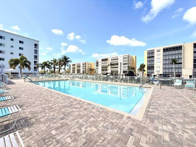 Community pool with lounge chairs