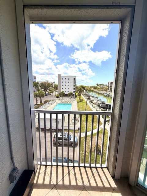 View of pool and marina from lanai