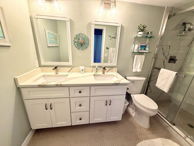 Primary bathroom with double vanity and shower
